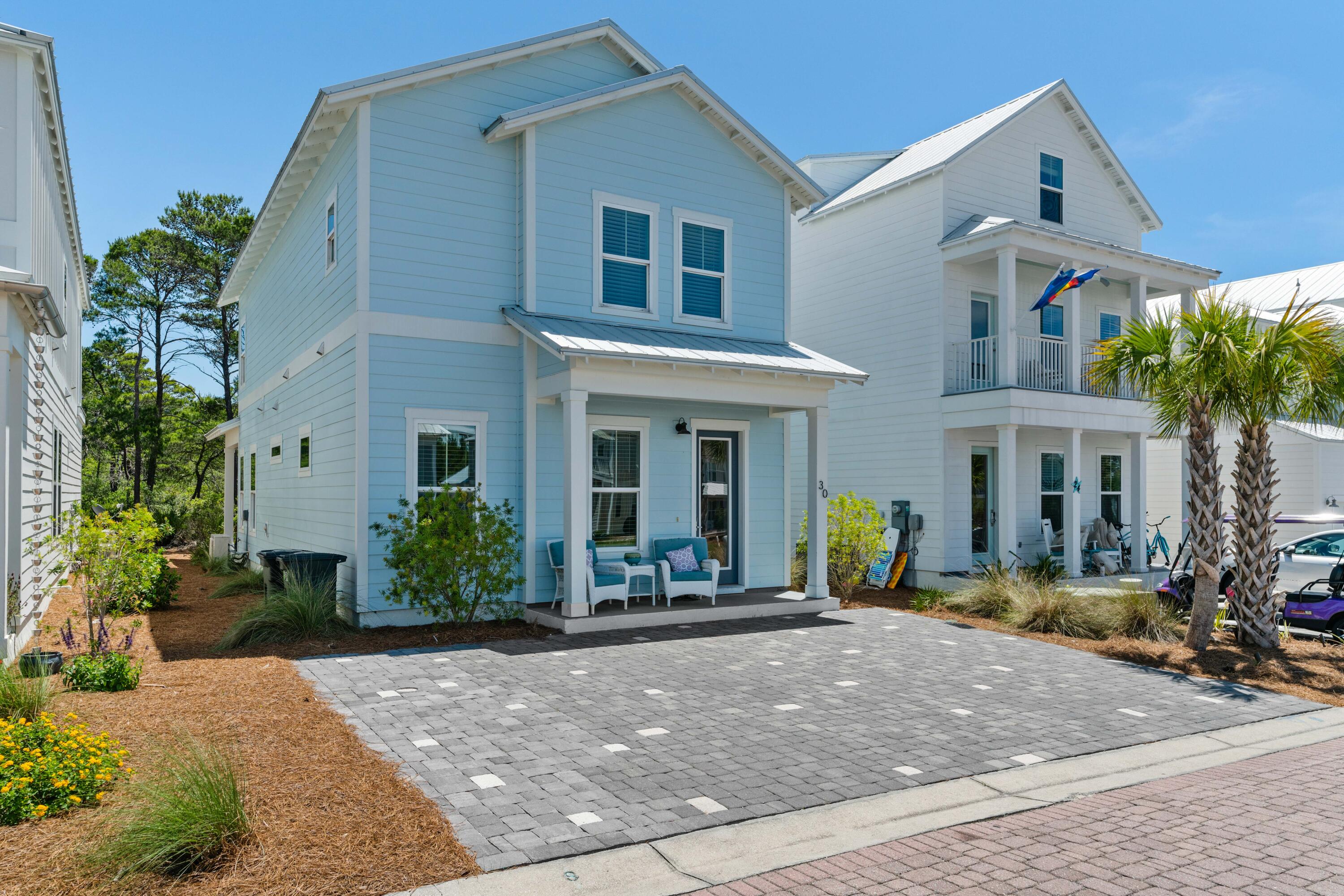 a front view of a house with garden and porch