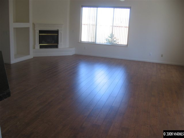 1677 Gemtown Drive Reno, NV 89521 - Photo 2 of 7 an empty room with wooden floor and windows