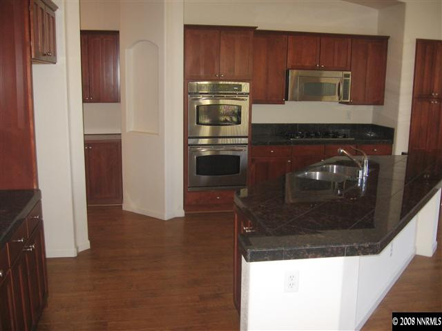 1677 Gemtown Drive Reno, NV 89521 - Photo 3 of 7 a kitchen with a refrigerator and cabinets