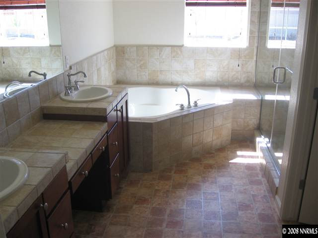 1677 Gemtown Drive Reno, NV 89521 - Photo 6 of 7 a bathroom with a sink a toilet and shower