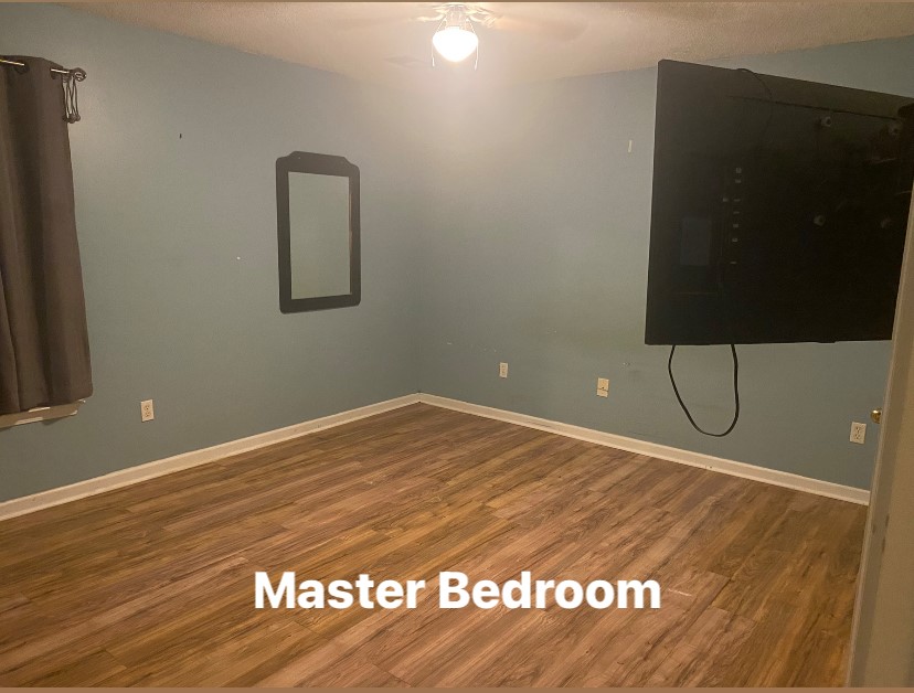 756B Maple Drive Greer, SC 29651 - Photo 7 of 10 A naturally illuminated bedroom offers durable, low-maintenance wood flooring, perfect for a cozy retreat.