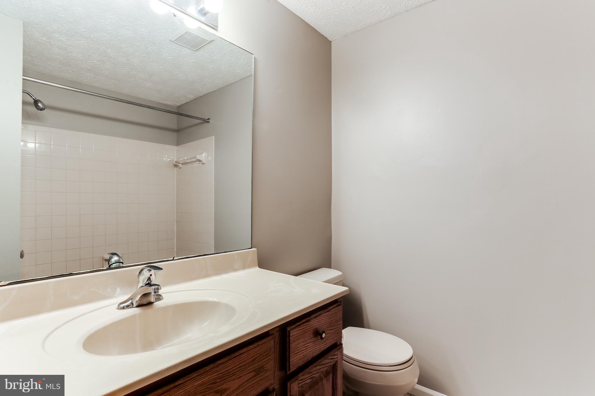 6 Ramsgate Court Halethorpe, MD 21227 - Photo 25 of 29 a bathroom with a sink toilet and a mirror