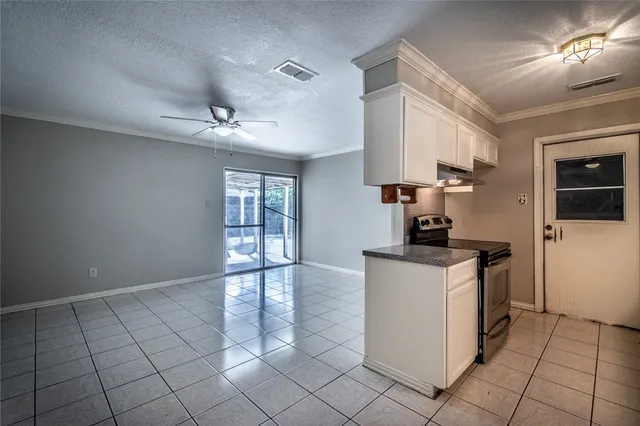 a kitchen with stainless steel appliances granite countertop a sink a stove and a refrigerator