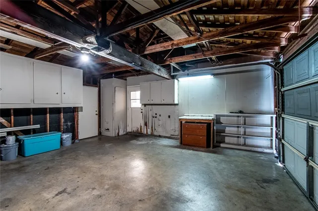 an empty room with a window and a ceiling fan