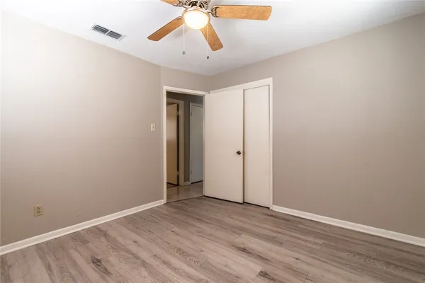 a bathroom with a granite countertop sink a toilet and a mirror