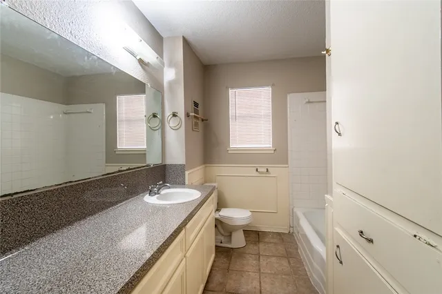 a bathroom with a sink a toilet and tub