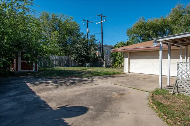 a view of a house with a yard and garage