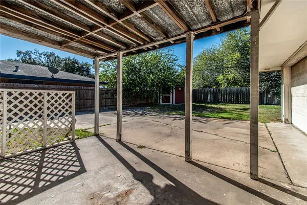 a porch with view of a backyard