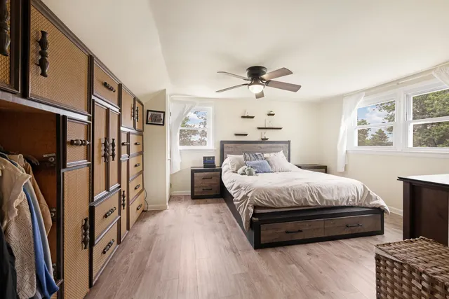 a spacious bedroom with a bed and a chandelier