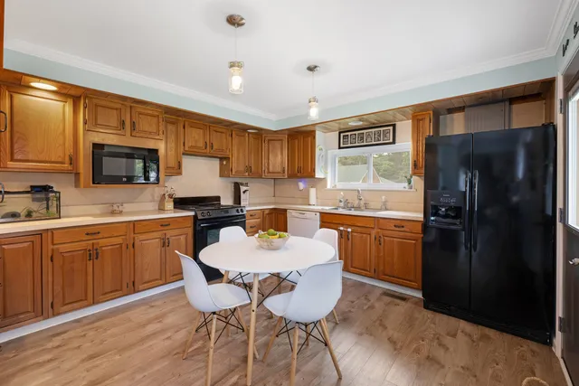 a kitchen with granite countertop a refrigerator stove microwave and sink