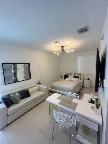 a bed room with a bed and a ceiling fan