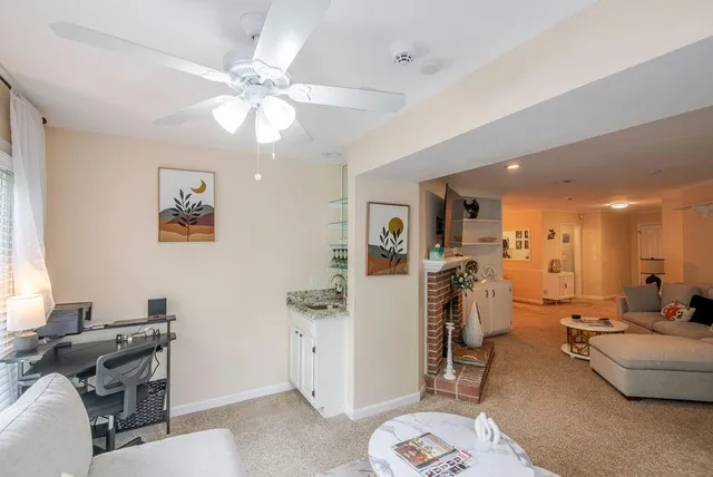 a view of a livingroom with workspace and a window