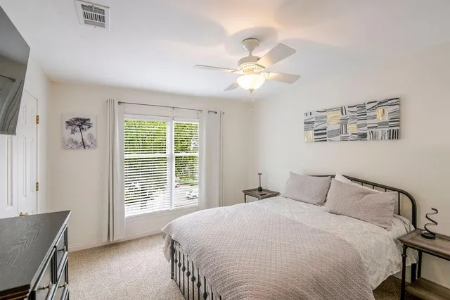 a bedroom with a large bed and a window