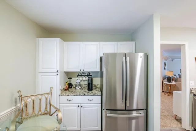 a kitchen with stainless steel appliances a refrigerator sink and cabinets