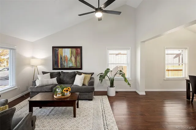 a living room with furniture and wooden floor