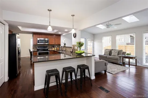 a large kitchen with a table and chairs