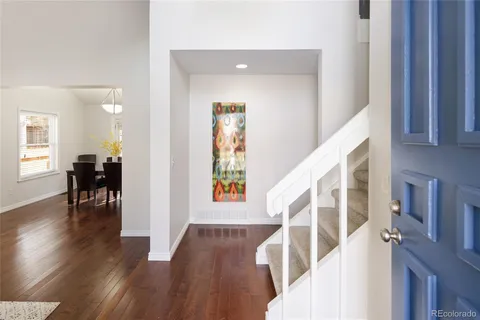 a view of entryway with wooden floor and stairs