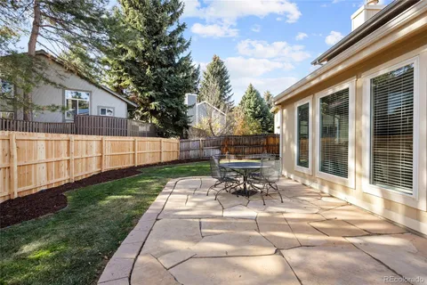 a view of a house with backyard and sitting area