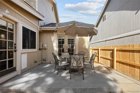 a view of a patio with table and chairs and potted plants