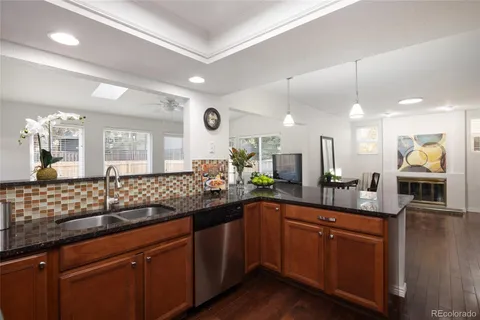 a kitchen with granite countertop a sink and cabinets