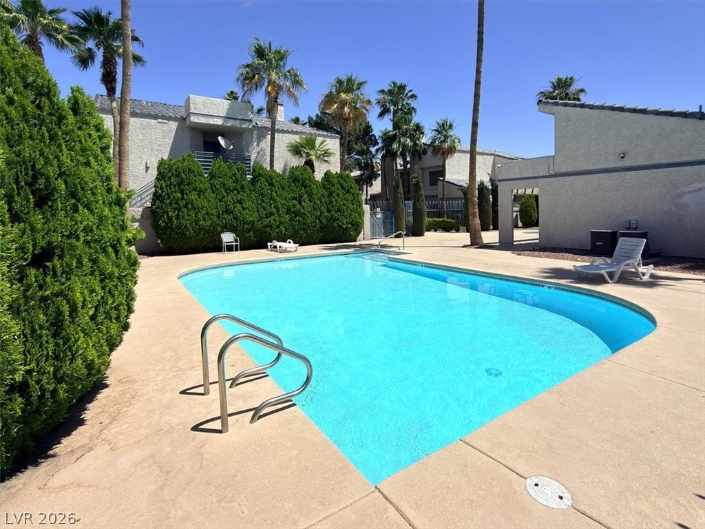 6250 West Flamingo Road, Unit 93 Las Vegas, NV 89103 - Photo 35 of 38 Relax poolside in this inviting outdoor space, surrounded by lush greenery and a tranquil atmosphere.