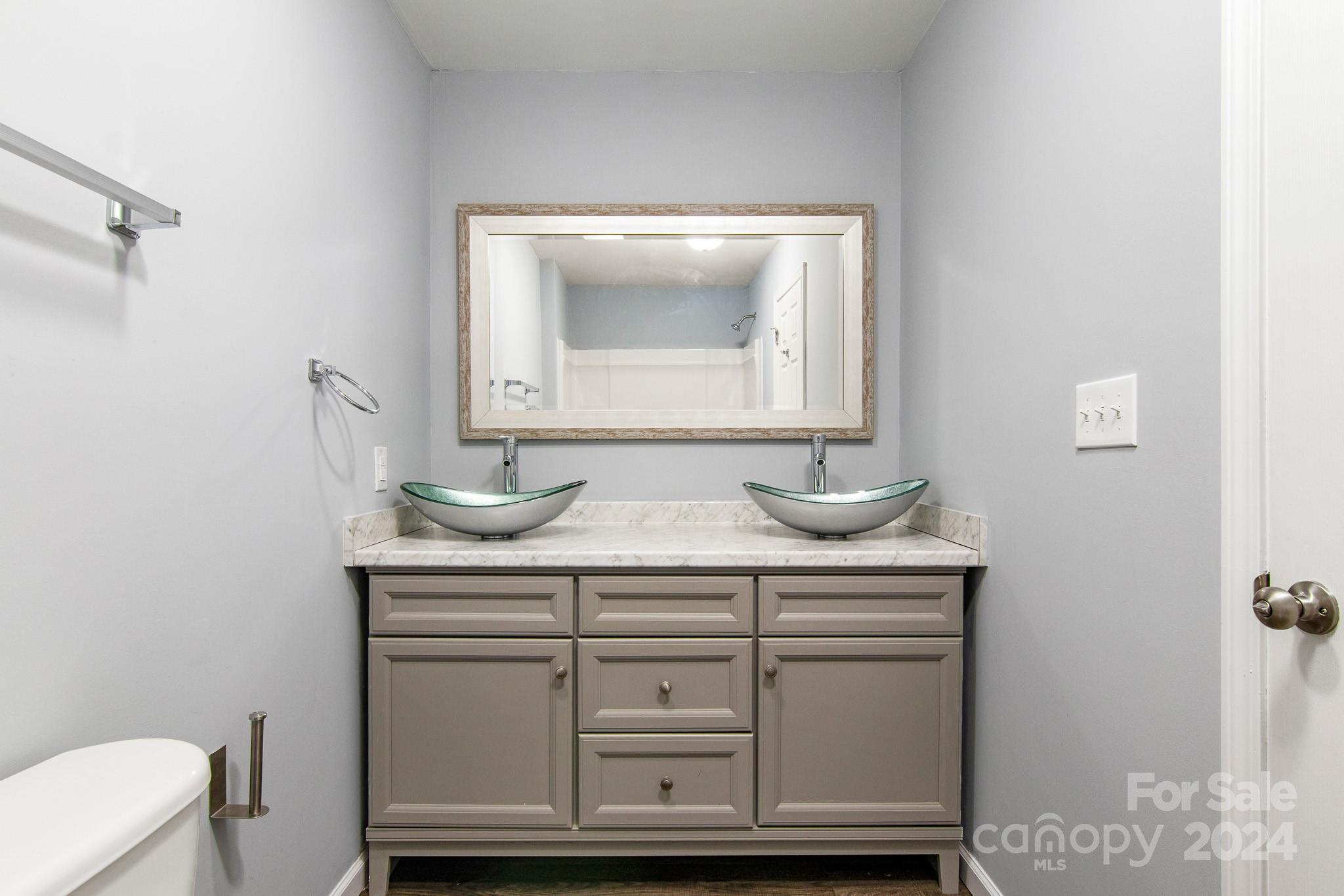 233 Charlotte Street York, SC 29745 - Photo 15 of 26 a bathroom with a sink a toilet and mirror