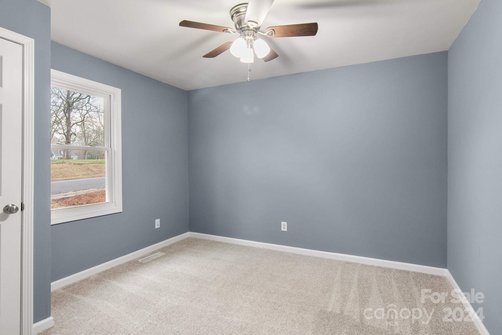 233 Charlotte Street York, SC 29745 - Photo 17 of 26 an empty room with a window and a fan