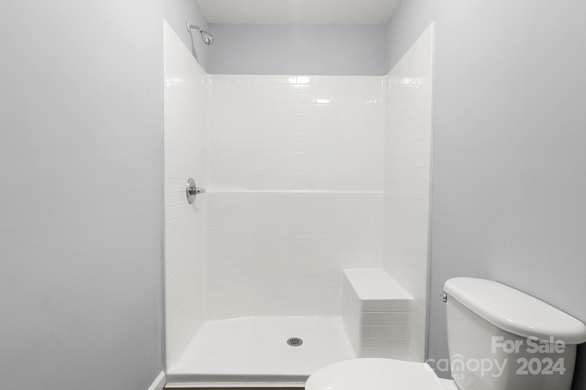 233 Charlotte Street York, SC 29745 - Photo 20 of 26 a white toilet sitting next to a bathroom sink