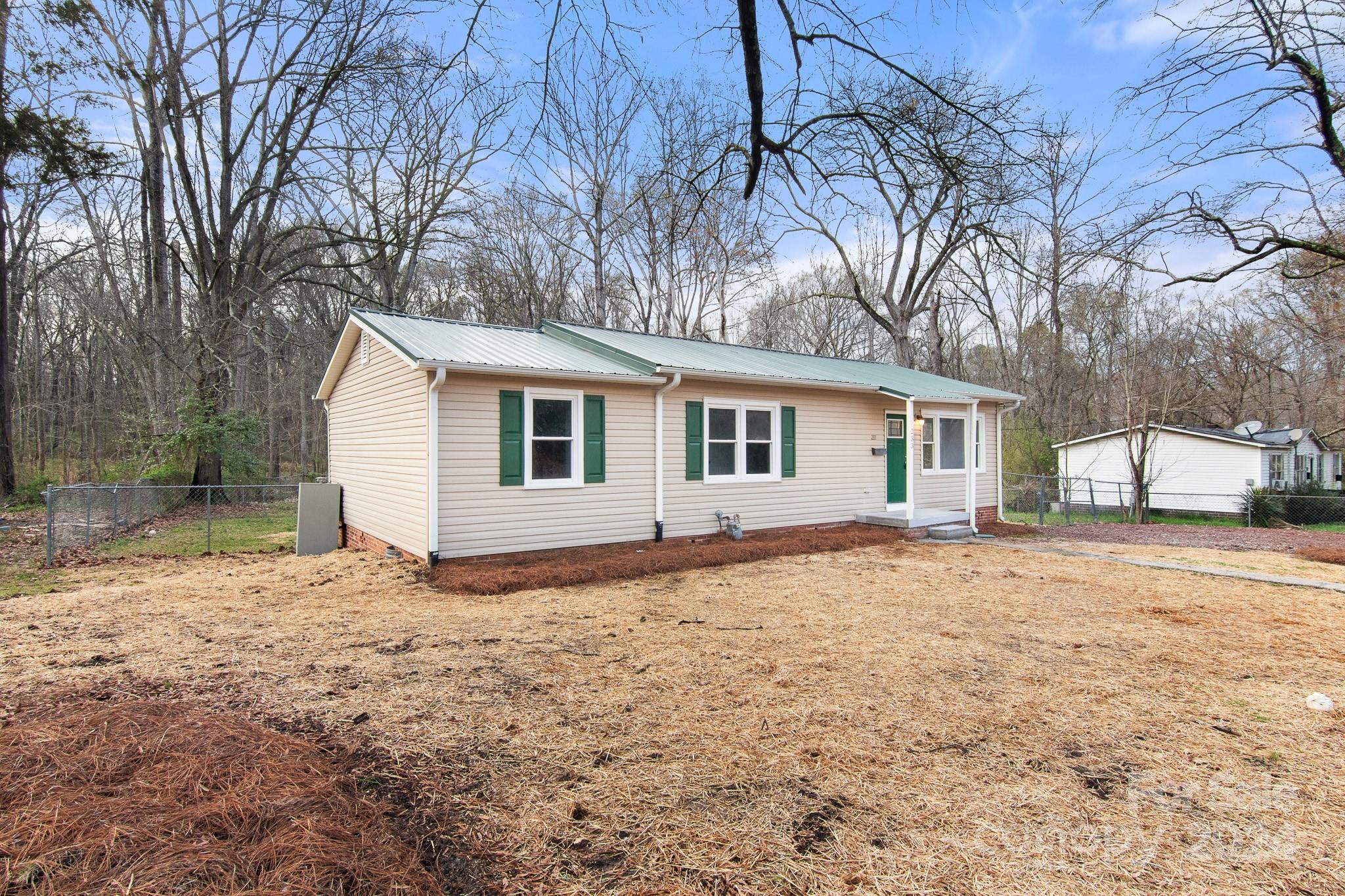 233 Charlotte Street York, SC 29745 - Photo 2 of 26 a view of a house with a yard covered with snow