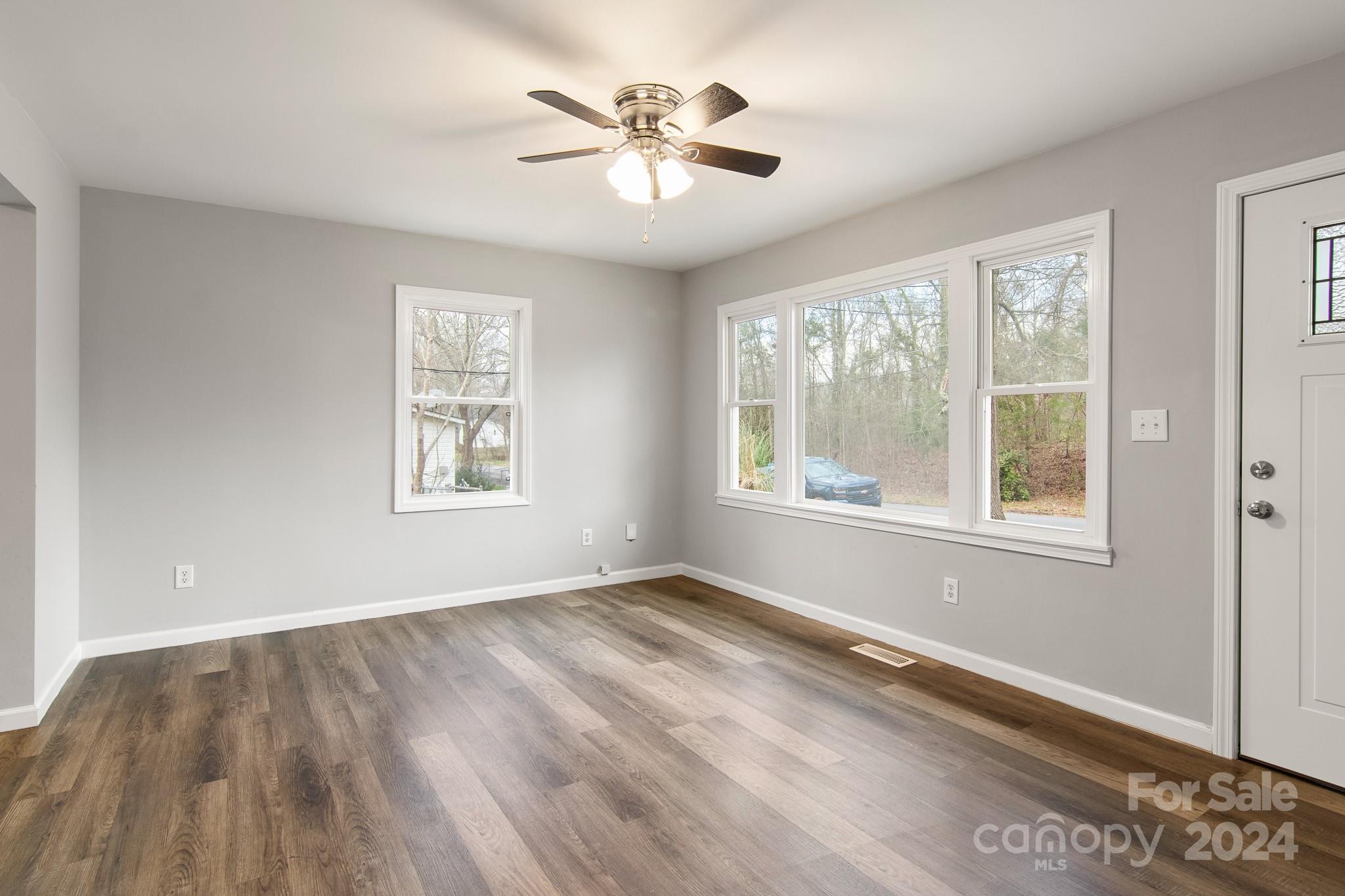233 Charlotte Street York, SC 29745 - Photo 4 of 26 a view of empty room with wooden floor and fan