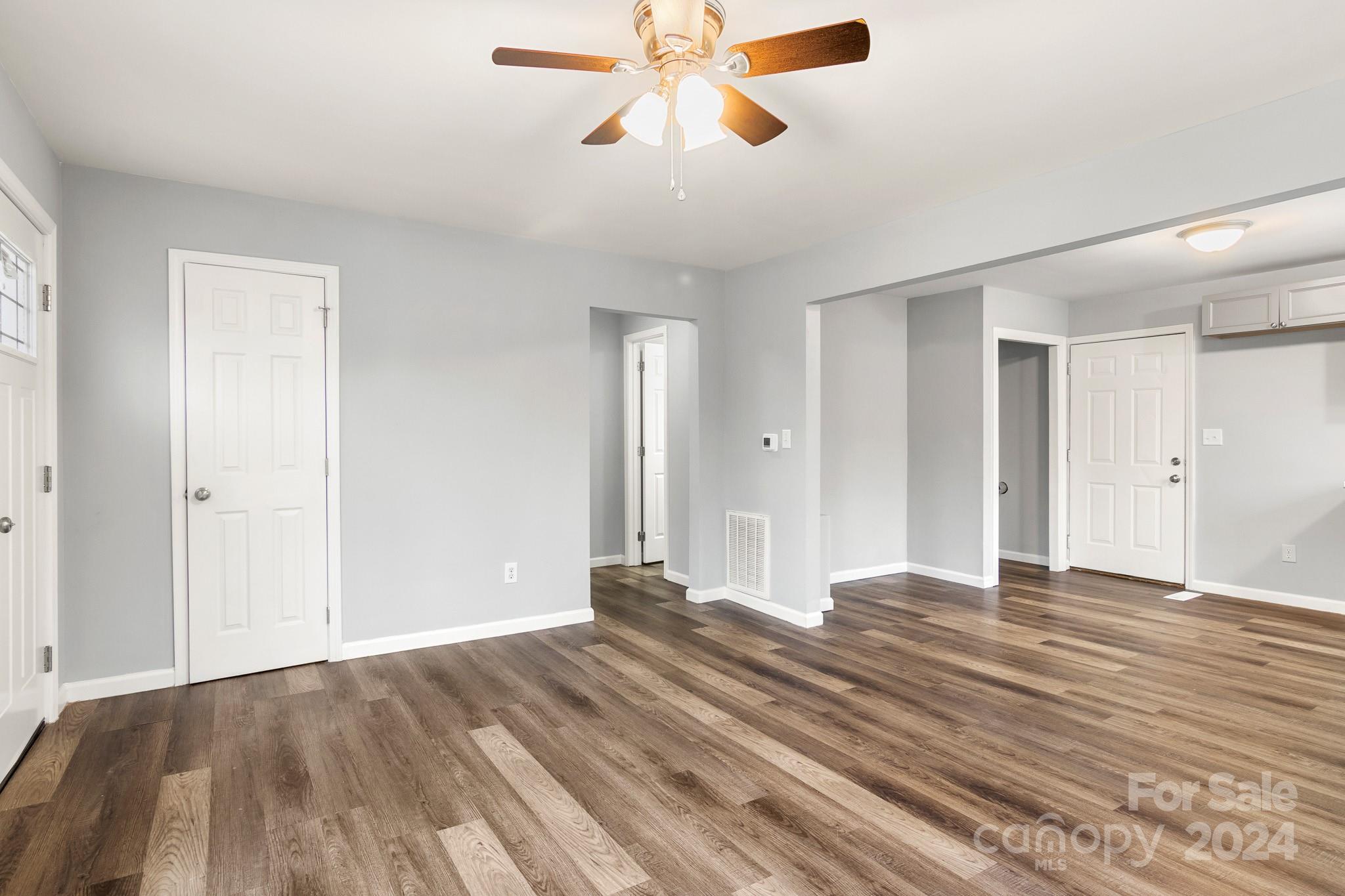 233 Charlotte Street York, SC 29745 - Photo 6 of 26 a view of empty room with wooden floor and fan
