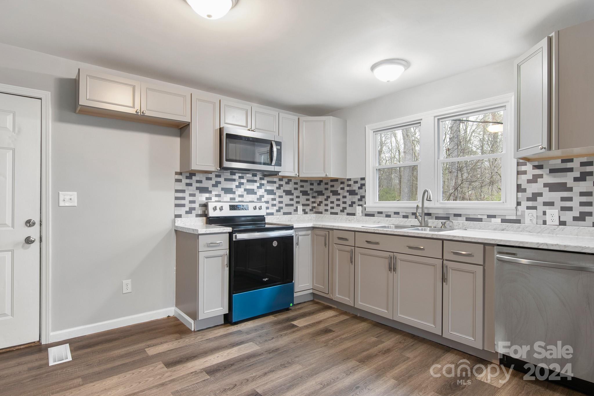 233 Charlotte Street York, SC 29745 - Photo 7 of 26 a kitchen with stainless steel appliances granite countertop a stove and a sink