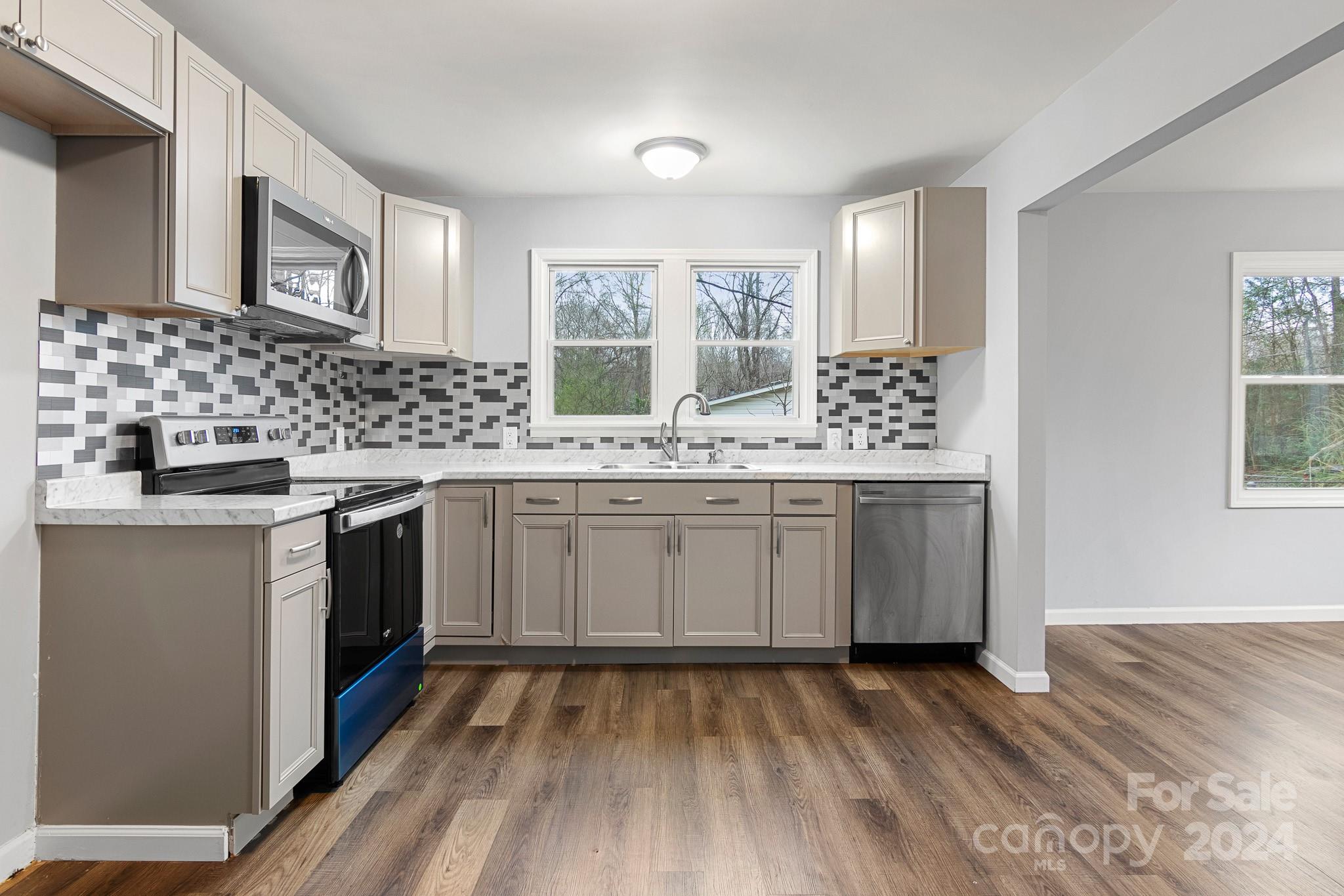 233 Charlotte Street York, SC 29745 - Photo 8 of 26 a kitchen with a sink stove and cabinets