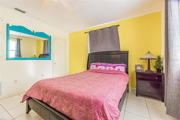 a bedroom with a bed dresser and a window