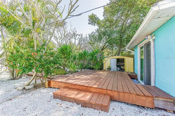 a view of a house with a yard and potted plants
