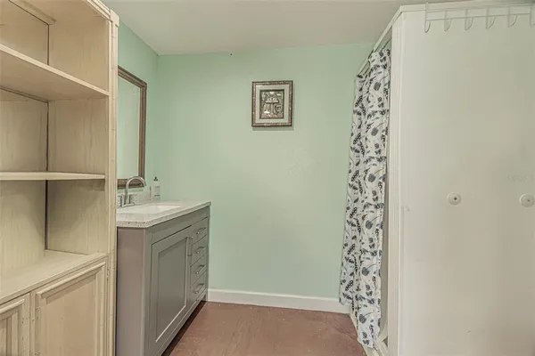 a white toilet sitting next to a white wall