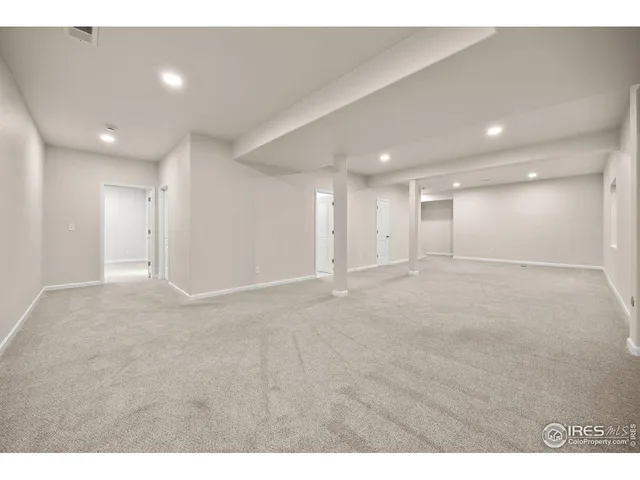 a bathroom with a granite countertop sink toilet and mirror
