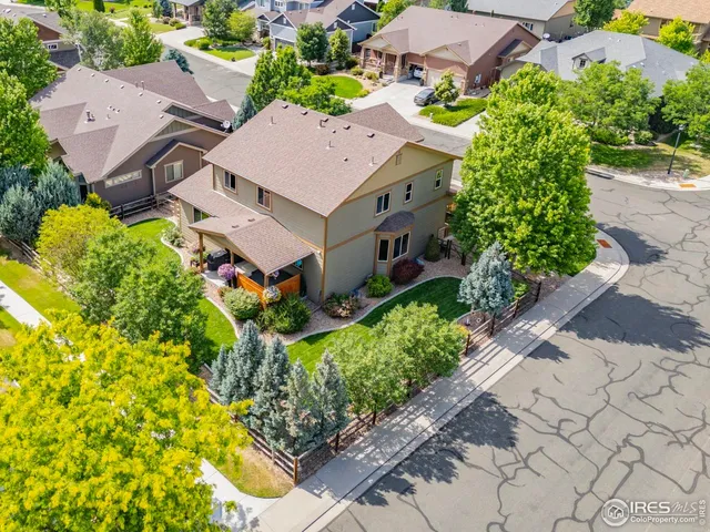 an aerial view of a house with a yard and garden