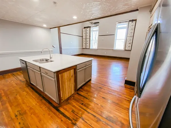 a kitchen with a cabinets and wooden floor