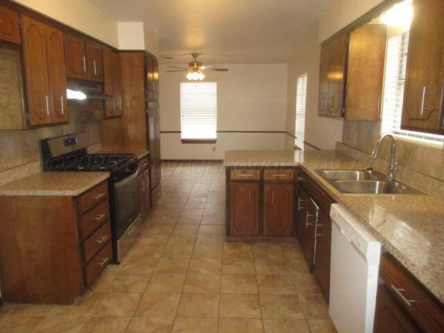 4904 South Georgia Street Amarillo, TX 79110 - Photo 11 of 12 a kitchen with a sink a stove and a refrigerator