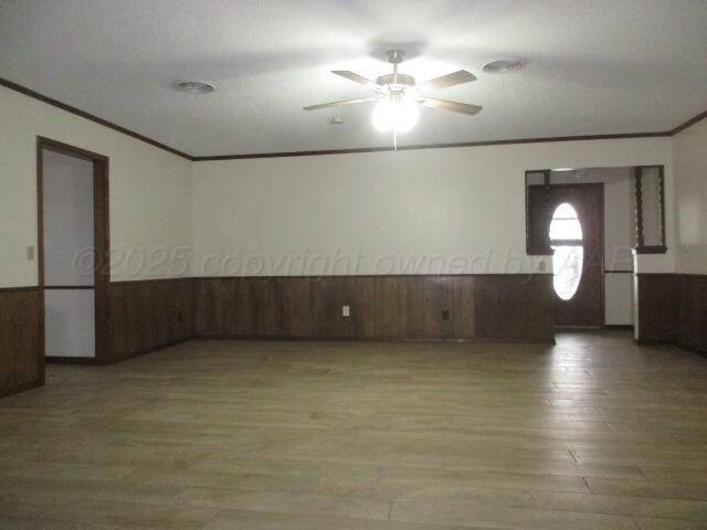 4904 South Georgia Street Amarillo, TX 79110 - Photo 2 of 12 an empty room with wooden floor and chandelier