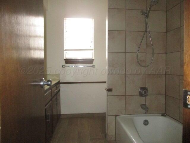 4904 South Georgia Street Amarillo, TX 79110 - Photo 4 of 12 a bathroom with a tub a sink and a window
