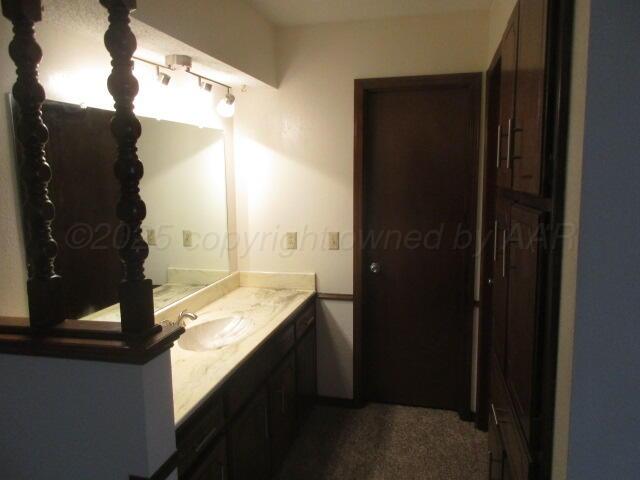 4904 South Georgia Street Amarillo, TX 79110 - Photo 7 of 12 a bathroom with a granite countertop shower and a sink