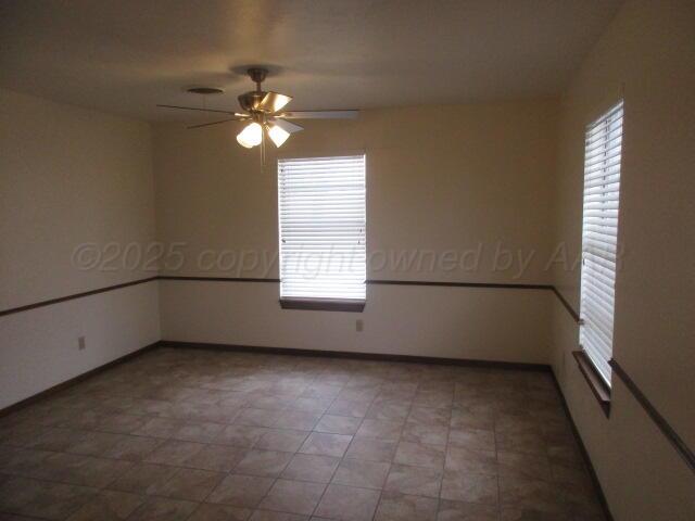 4904 South Georgia Street Amarillo, TX 79110 - Photo 10 of 12 an empty room with windows and fan