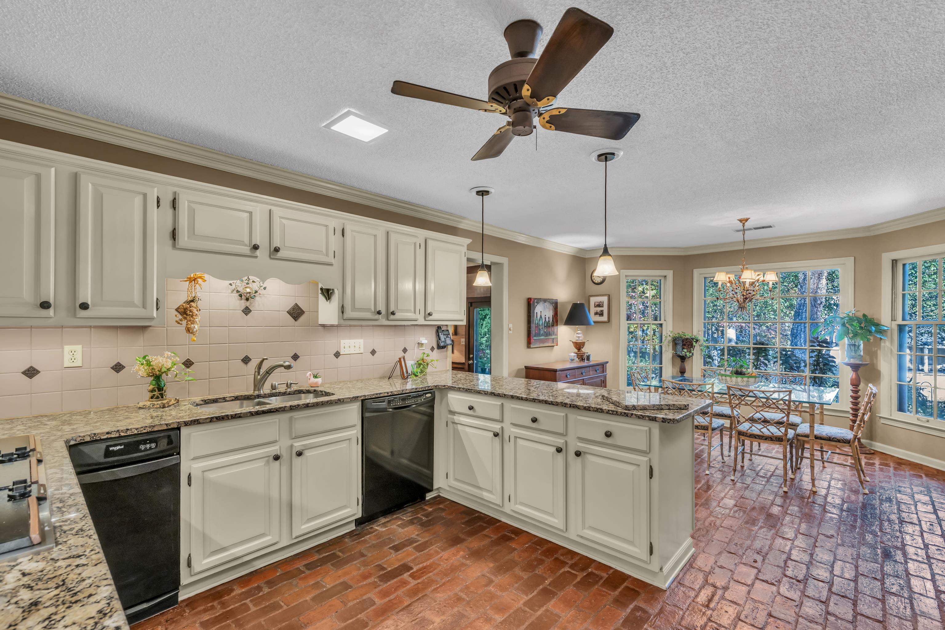 2002 Magnolia Ridge Cove Germantown, TN 38138 - Photo 12 of 40 Kitchen with black dishwasher, kitchen peninsula, sink, and plenty of natural light
