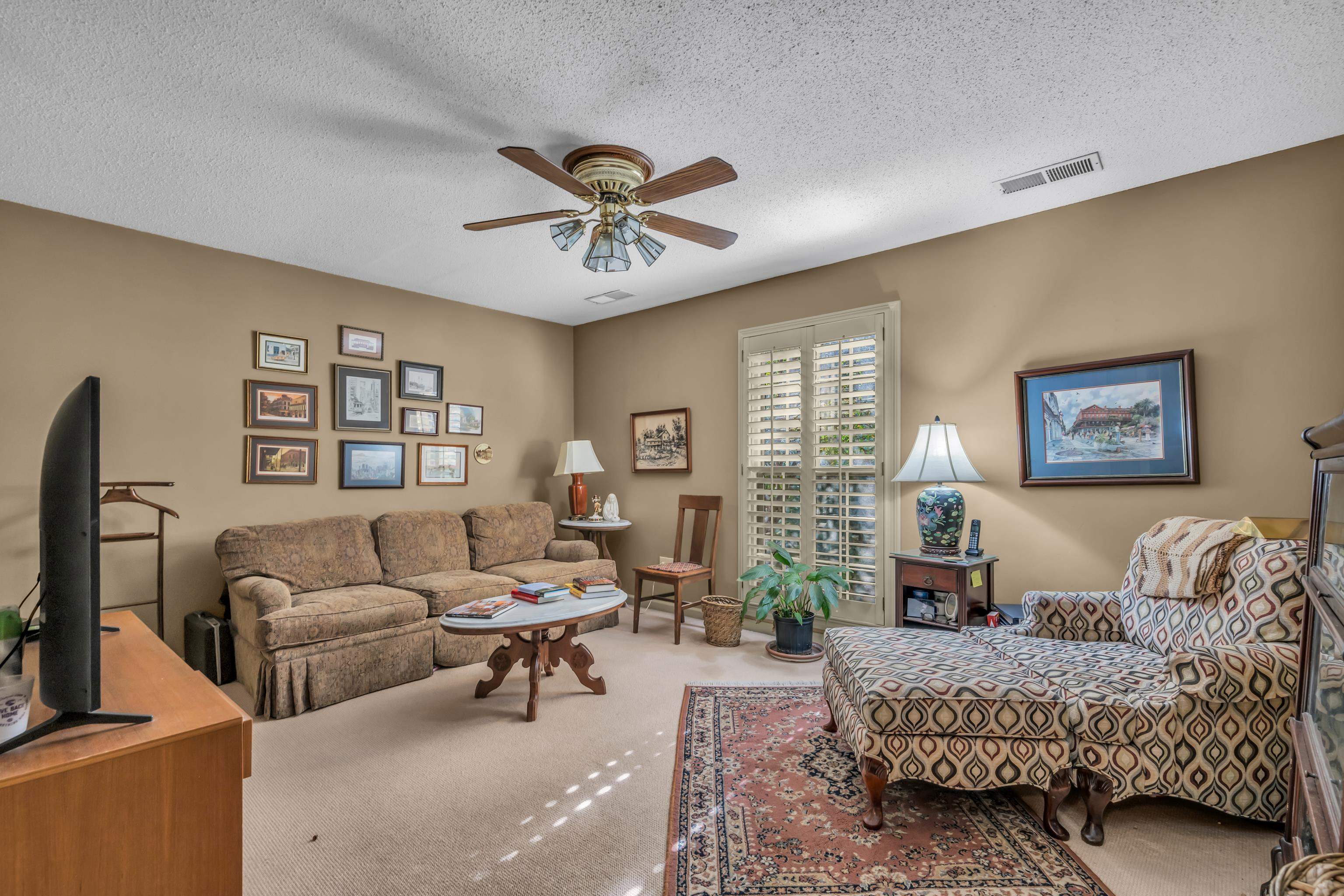 2002 Magnolia Ridge Cove Germantown, TN 38138 - Photo 24 of 40 Living room with a textured ceiling, carpet flooring, and ceiling fan