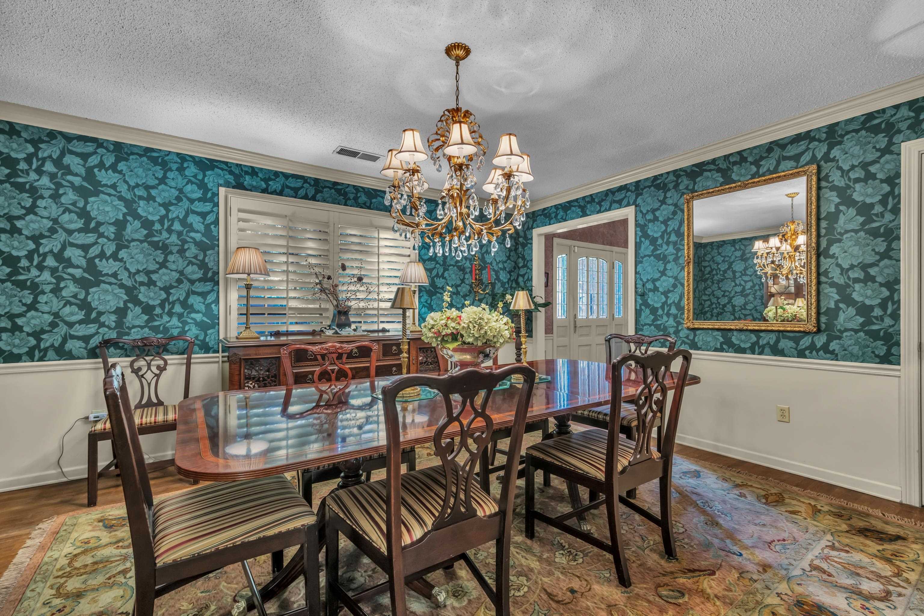 2002 Magnolia Ridge Cove Germantown, TN 38138 - Photo 7 of 40 Dining area with an inviting chandelier, crown molding, wood-type flooring, and a textured ceiling