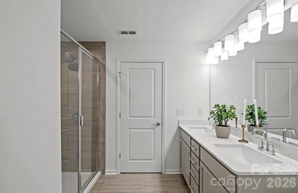 a bathroom with a double vanity sink and a mirror