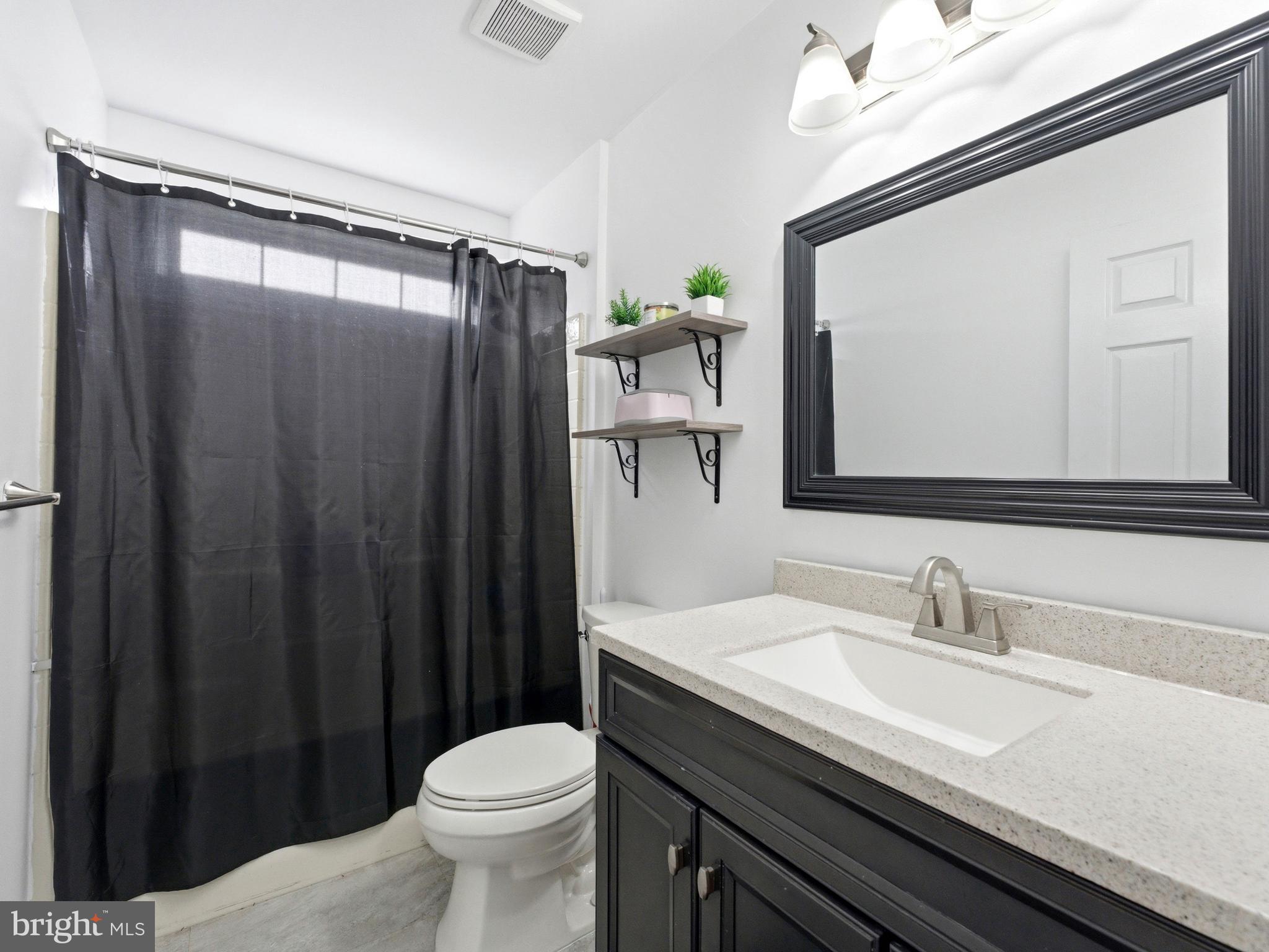 101 Weatherhill Court Hainesport, NJ 08036 - Photo 25 of 41 a bathroom with a sink a toilet a mirror and shower curtain