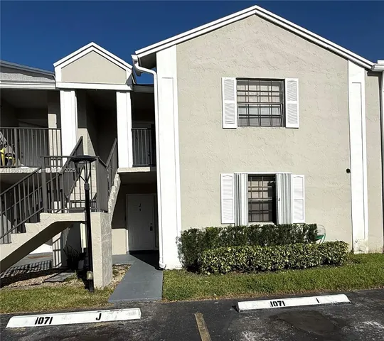 a front view of a house with stairs